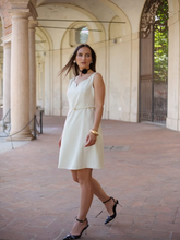 A woman wears a worsted wool vest dress